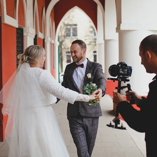 a videographer is taking a video of a bride and groom